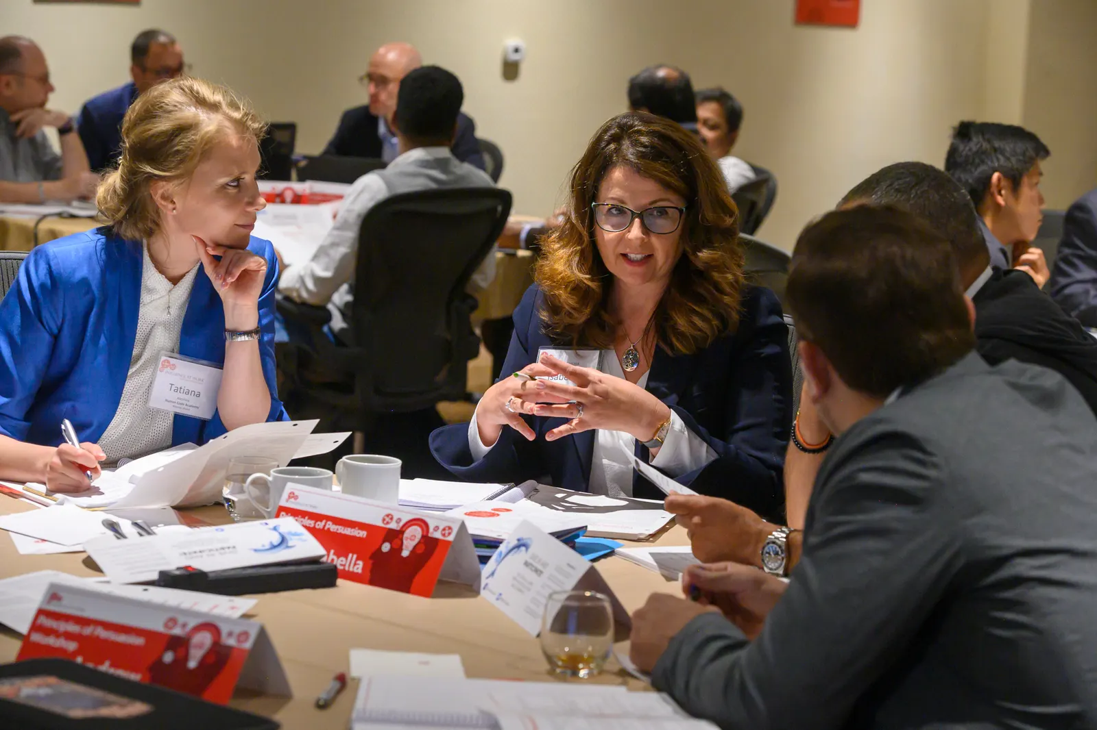 Two participants discussing a case at a POP workshop table